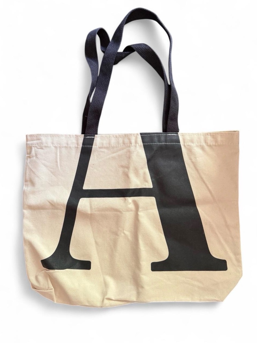 THE ATLANTIC  magazine tote bag with black letter 'A' on cream background.